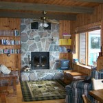 Comfortable living room. Elevated knotty pine ceilings and walls. Fireplaces. TV/DVD