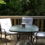 Pine entrance deck with outdoor patio dining furniture.