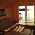 Newly renovated boathouse – a pine-finished bunkie right on the water with futon, bar, stools and bar fridge