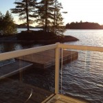 Deck of boathouse/bunkie overlooks little island and miles of lake, facing NW for terrific sunsets!