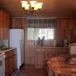 Plenty of pine cupboard space in fully equipped kitchen. Teak dining table seats 8+.