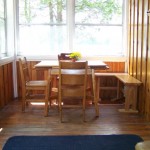 Cozy kitchen nook in solarium overlooks lake.