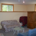 Finished basement and rec room with Entertainment center. Wood table and chairs in far corner for extra dining space.