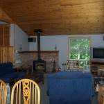 Spacious, open concept living room & dining room. Vaulted pine ceilings. Satellite TV/DVD. High efficiency woodstove.